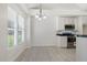 Kitchen with tile floors, white cabinets, stainless steel appliances and natural light at 3404 Apple Meadow Dr, Fuquay Varina, NC 27526