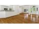 Living room with hardwood floors leading to entry and open kitchen at 3404 Apple Meadow Dr, Fuquay Varina, NC 27526