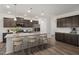 Bright kitchen featuring granite countertops, stainless steel appliances, a kitchen island, and stylish pendant lighting at 353 Bridle Brook Way, Fuquay Varina, NC 27526