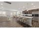 Open-concept kitchen with granite countertops, stainless steel appliances, island with seating, and hardwood floors at 353 Bridle Brook Way, Fuquay Varina, NC 27526