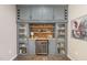 Elegant bar area with custom cabinetry, wine fridge, and glass display shelves at 3609 Jordan Shires Dr, New Hill, NC 27562