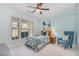 Bright bedroom featuring a ceiling fan, a cozy reading chair, and large windows that let in plenty of natural light at 3609 Jordan Shires Dr, New Hill, NC 27562
