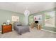 Bright carpeted bedroom featuring a twin bed, desk, and overhead lighting fixture at 3609 Jordan Shires Dr, New Hill, NC 27562