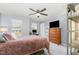 Cozy bedroom with gray walls, large TV, and a ceiling fan at 3609 Jordan Shires Dr, New Hill, NC 27562