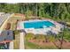 Aerial view of the community pool surrounded by mature shade trees at 3609 Jordan Shires Dr, New Hill, NC 27562