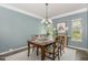 Comfortable dining room with views, a chandelier, and a table set for four at 3609 Jordan Shires Dr, New Hill, NC 27562
