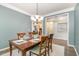 Cozy dining room with views, a chandelier, and a table set for four at 3609 Jordan Shires Dr, New Hill, NC 27562