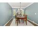 Formal dining room with wood table, chandelier, and natural light at 3609 Jordan Shires Dr, New Hill, NC 27562