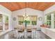 Inviting dining room features a wood-planked ceiling, wainscoting, and natural light at 3609 Jordan Shires Dr, New Hill, NC 27562