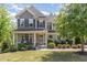 Charming two-story home featuring a welcoming front porch and professionally landscaped yard at 3609 Jordan Shires Dr, New Hill, NC 27562