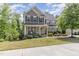 Charming two-story home with a welcoming front porch and mature landscaping at 3609 Jordan Shires Dr, New Hill, NC 27562
