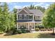 Charming two-story home featuring a welcoming front porch and professionally landscaped yard at 3609 Jordan Shires Dr, New Hill, NC 27562