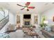 Bright living room with a stone fireplace, ceiling fan, and open staircase at 3609 Jordan Shires Dr, New Hill, NC 27562