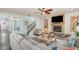 Spacious living room featuring a stone fireplace, ceiling fan, and cozy furnishings at 3609 Jordan Shires Dr, New Hill, NC 27562