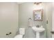 Stylish powder room features a pedestal sink and decorative mirror at 3609 Jordan Shires Dr, New Hill, NC 27562