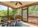 Cozy sunroom with ceiling fan, screened windows, and a comfortable seating area for relaxing at 3609 Jordan Shires Dr, New Hill, NC 27562