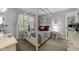 Charming bedroom with four poster bed and bright natural light at 404 Emerywood Dr, Raleigh, NC 27615