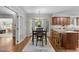 Dining area with bay window, wood floors, and access to kitchen island at 404 Emerywood Dr, Raleigh, NC 27615