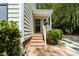 Charming entrance features brick steps and covered porch at 404 Emerywood Dr, Raleigh, NC 27615