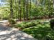 The house is set back from the street and is surrounded by mature trees and professionally manicured landscaping at 404 Emerywood Dr, Raleigh, NC 27615