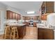 Kitchen with wood cabinets, stainless appliances, granite counters and a large island at 404 Emerywood Dr, Raleigh, NC 27615