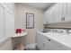 Bright laundry room with ample cabinet space and modern appliances at 404 Emerywood Dr, Raleigh, NC 27615