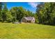 Expansive backyard with above-ground pool and well-maintained lawn, surrounded by mature trees at 4072 Mackenzie Dr, Haw River, NC 27258
