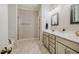 Bright bathroom featuring a double vanity, white cabinets, and marble floors at 4072 Mackenzie Dr, Haw River, NC 27258