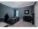This is a secondary bedroom that is painted in a flat dark color with carpeted floors at 4072 Mackenzie Dr, Haw River, NC 27258