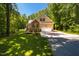 Charming home featuring brick and tan siding, a two-car garage, and a well-manicured lawn at 4072 Mackenzie Dr, Haw River, NC 27258