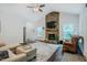 Bright living room featuring a stone fireplace and hardwood floors at 4072 Mackenzie Dr, Haw River, NC 27258