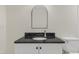 Close-up of bathroom vanity with granite countertop and brushed nickel faucet at 410 Caswell St, Burlington, NC 27217