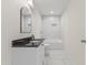 Updated bathroom with marble tile, black granite counters, and modern fixtures at 410 Caswell St, Burlington, NC 27217
