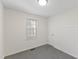 Bedroom with a window, carpeted floors and white walls at 410 Caswell St, Burlington, NC 27217