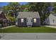 Charming single-story home with a manicured lawn, complemented by a gray exterior and a welcoming front porch at 410 Caswell St, Burlington, NC 27217