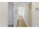 Light-filled hallway with wood-look flooring and white doors at 410 Caswell St, Burlington, NC 27217