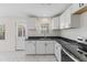Modern kitchen boasting white cabinets, new countertops, and stainless steel appliances with new marble flooring at 410 Caswell St, Burlington, NC 27217