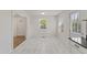 Spacious dining area bathed in natural light, seamlessly connecting the kitchen, featuring new marble flooring at 410 Caswell St, Burlington, NC 27217