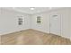 Inviting open living space featuring modern floors and neutral walls, illuminated by natural light from two windows at 410 Caswell St, Burlington, NC 27217