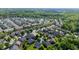 Aerial view displaying a Primary-planned community with winding streets, manicured lawns, and mature trees in the neighborhood at 4116 Argyle Trl, Burlington, NC 27215