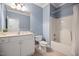 Charming bathroom with blue walls, a white vanity, and a shower-tub combination at 4116 Argyle Trl, Burlington, NC 27215