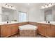 Bathroom with dual sinks, tile flooring, and tub in tiled nook under a window at 4116 Argyle Trl, Burlington, NC 27215