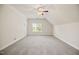 Neutral bedroom with carpet, vaulted ceiling, and a window for natural light at 4116 Argyle Trl, Burlington, NC 27215