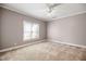 Spacious bedroom with neutral walls, carpet flooring, and a window for natural light at 4116 Argyle Trl, Burlington, NC 27215