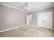 Bright bedroom featuring white trim, carpet flooring, ceiling fan, and a double-door closet at 4116 Argyle Trl, Burlington, NC 27215