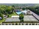 Aerial view showcases a clubhouse, pool, and tennis and basketball courts surrounded by lush landscaping at 4116 Argyle Trl, Burlington, NC 27215