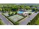 Aerial view of the community clubhouse, pool, tennis courts, and basketball court in a well-maintained neighborhood at 4116 Argyle Trl, Burlington, NC 27215
