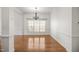 Dining room showcasing gleaming hardwood floors, and a modern chandelier at 4116 Argyle Trl, Burlington, NC 27215