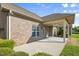 A brick home showcases a covered patio, perfect for enjoying the outdoors at 4116 Argyle Trl, Burlington, NC 27215
