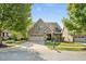 Charming brick home with a two-car garage, manicured lawn and stone accents, presenting inviting curb appeal at 4116 Argyle Trl, Burlington, NC 27215